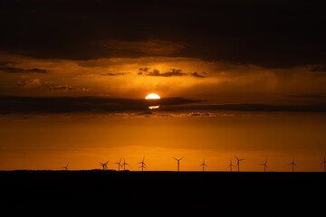 Wind Turbines renewable energy at sunset 