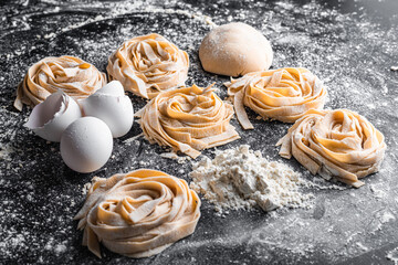 cooking pasta machine work fresh and raw on black background