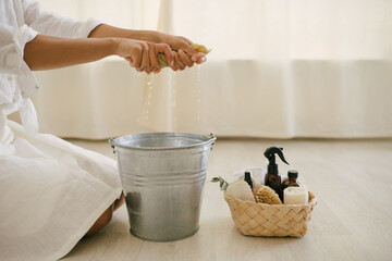 Young woman cleaning room using natural wooden brush. Sustainable eco friendly tools for cleaning.