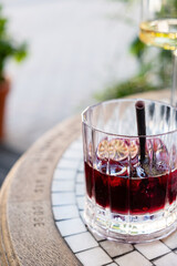 iced cocktail with berries and orange