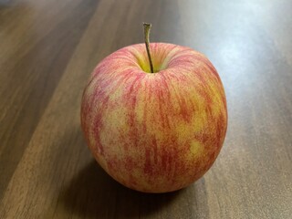 red apple on wooden table