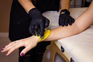woman depilation procedure wax sugaring spa