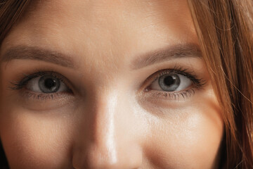 Fototapeta premium Close-up female face. Beautiful eyelashes and eyebrows. Concept of natural beauty, cosmetics, anti age treatment, wellness