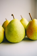 ripe juicy yellow-green pears on a white background
