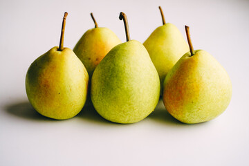 ripe juicy yellow-green pears on a white background