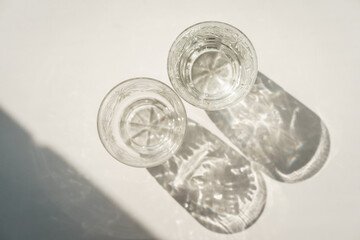 two crystal glasses with patterns on a white background