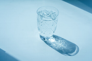 beautiful crystal glass with a pattern on a white background and its shadow