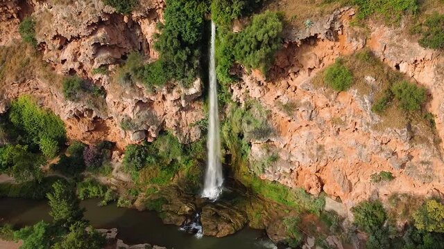 Beautiful aerial view of waterfall Salto de la novia in Navajas, Spain. Rotating drone shot of breathtaking waterfall and valley with river.