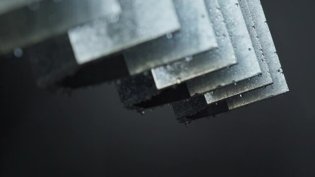Close-up of Disinfection Lamp Metal Housings Hanging in a Row. Being Air Dried After Washing. Water Drops Running Down the Surface. Production of Medical Equipment. Industrial Facility.
