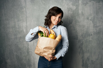 pretty woman with package of groceries supermarket healthy food