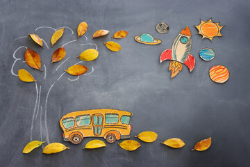 Back to school concept. Top view banner of school bus next to tree sketch with autumn dry leaves...