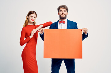 a man in a suit next to a woman in a red dress advertising presentation Copy Space