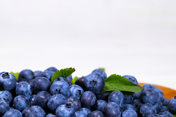 Close up of Blueberry With a Green Mint leaf on a white top view, Summer Freshly Berry, Copyspace