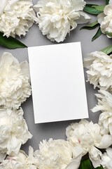 Obraz na płótnie Canvas Invitation or greeting card mockup with white peony flowers and eucalyptus twigs