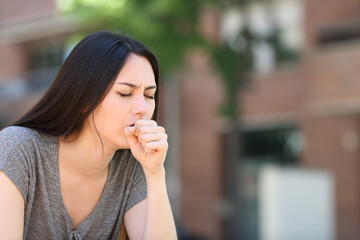 Fototapeta na wymiar Asian woman coughing in the street
