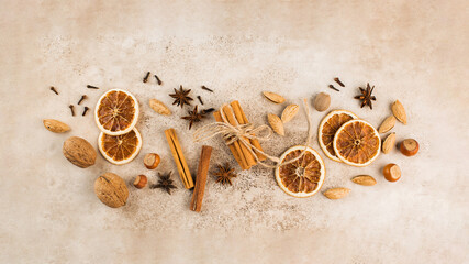 Cinnamon sticks, slices of dried orange, star anise. Top view. Autumn background. The concept of...