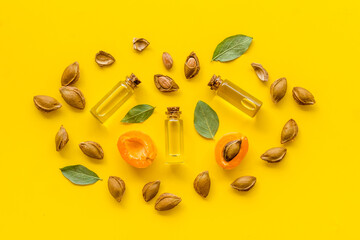 Bottles of apricot kernel oil with ripe apricot fruits