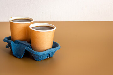 Take out coffee in paper cups on the table. Close up