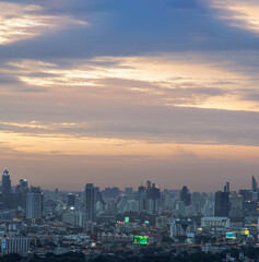 Fototapeta premium Bangkok, Thailand - Aug 04, 2021: Aerial view of Beautiful scenery view of Skyscraper Evening time Sunset creates relaxing feeling for the rest of the day. Selective focus.