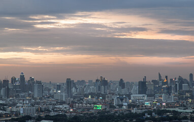 Fototapeta na wymiar Bangkok, Thailand - Aug 04, 2021: Aerial view of Beautiful scenery view of Skyscraper Evening time Sunset creates relaxing feeling for the rest of the day. Selective focus.