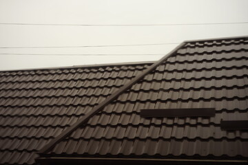 House with brown tiled roof in rainy overcast day