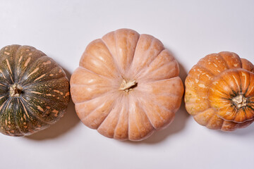 Various pumpkins on white background . Top view