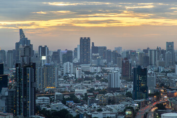 Fototapeta na wymiar Bangkok, Thailand - Aug 04, 2021: Aerial view of Beautiful scenery view of Skyscraper Evening time Sunset creates relaxing feeling for the rest of the day. Selective focus.