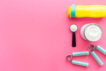 Sport protein shake smoothie in bottle with gym accessories