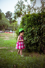 Naklejka premium portrait of cute indian baby girl playing in the park.