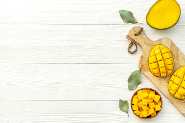 Mango fruits and mango cubes in bowl. Tropical breakfast. Overhead view