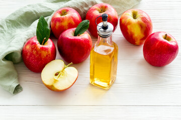 Apple cider vinegar in a bottle with fresh apples