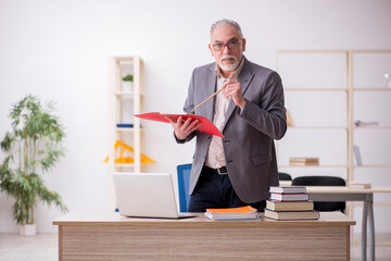 Aged male teacher in the classroom