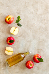 Apple cider vinegar in a bottle with fresh apples
