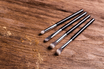 Mineral powder foundation with brushes on a wooden background. Eco-friendly and organic beauty products