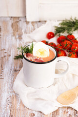 Spanish salmorejo cream soup with ham and egg