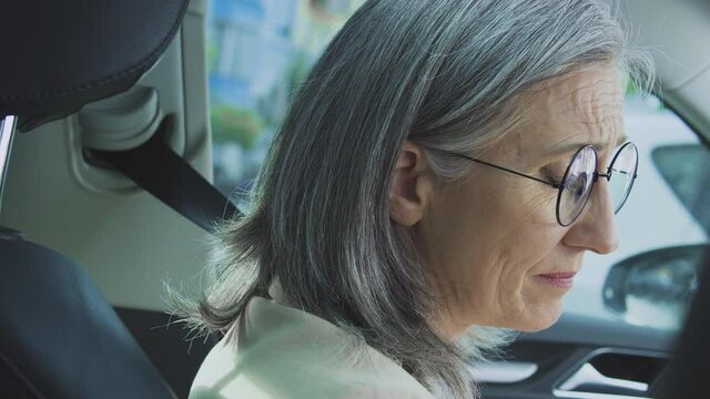 Depressed middle-aged woman feeling sorrow sitting in car, end of relationships