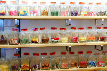 Different lollipops in candy shop. Sweet bonbons with different flavours.