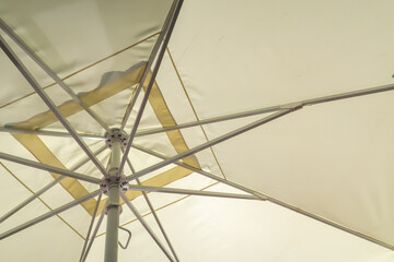 sand-colored parasol from the inside as a background