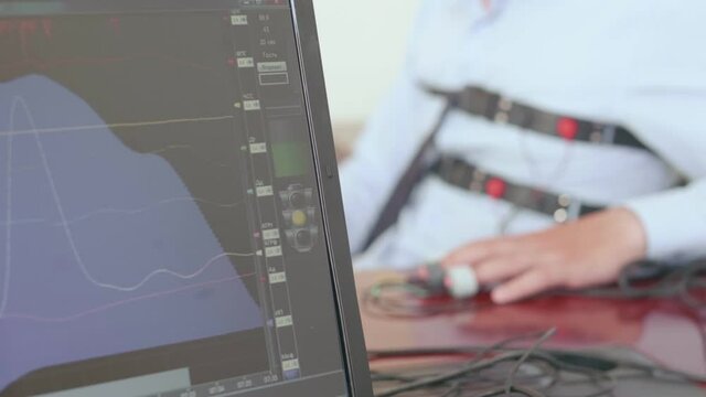 A person is being tested on a lie detector