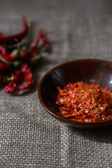 Dry chili peppers, coarsely ground.