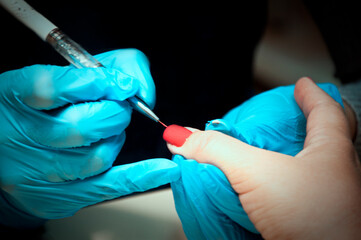 painting nails manicure in a beauty salon at the master, hand care. High quality photo