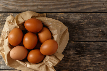 Ecological farm chicken eggs on a rustic wooden table.