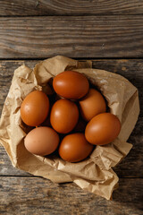 Ecological farm chicken eggs on a rustic wooden table.