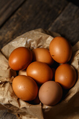 Ecological farm chicken eggs on a rustic wooden table.