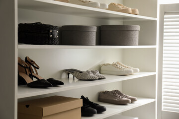Storage rack with stylish women's shoes indoors