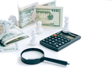 Magnifier, calculator, paper money and white chess isolated on white background with copy space....
