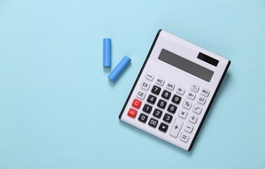 CAlculator with aa batteries on blue background. Top view