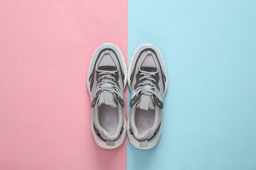 Sports sneakers on a blue-pink pastel background. Running shoes. Pastel color trend