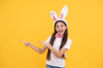 amazed teen girl in bunny ears presenting product or shopping sales, copy space, easter holiday.