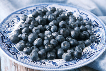 Close up of fresh blue berry with water drops .